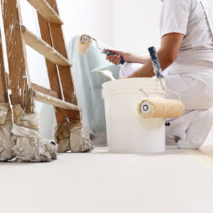 painter man at work with a roller, bucket and scale, from below view, copy space template painter man at work with a roller, bucket and scale, from below view, copy space template